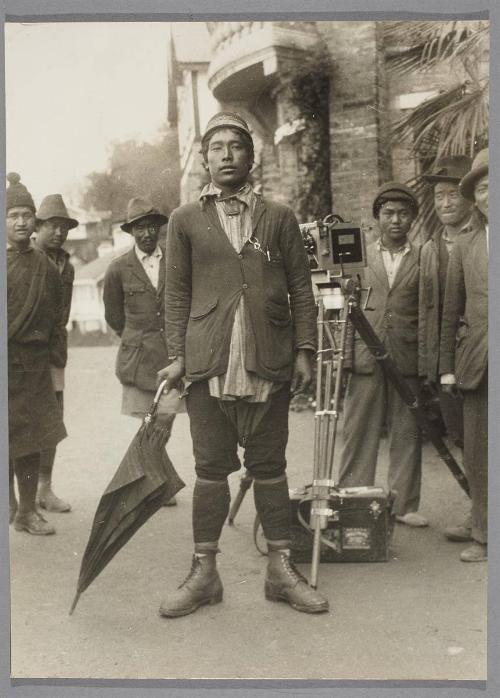 The Dandy of Darjeeling. A complete western outfit, even down to watch chain and clip-on pencil, and of course the umbrella must not be left behind; it is the insignia of the fashionable man in Darjeeling.
