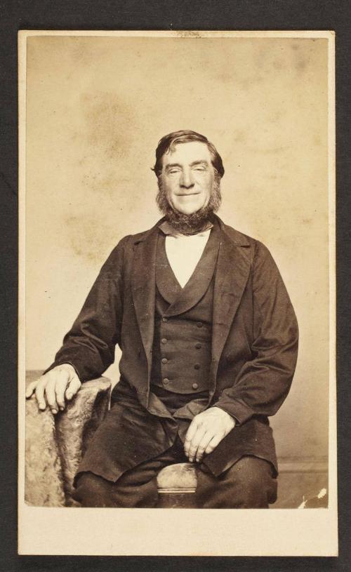 Unknown sitter [portrait of a seated man with his right hand on side table]