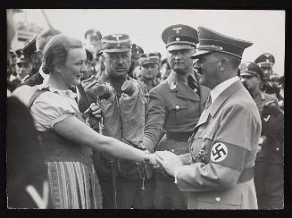 Hitler shaking hands with a woman.
