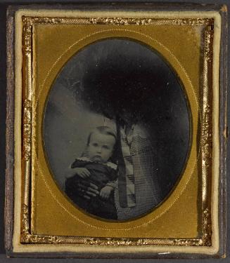 Portrait of a young boy with white collar (seated on lap)