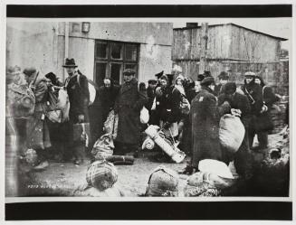 Deportation of residents with sacks and bedrolls