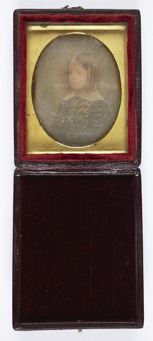 [Portrait of a young girl with curls]