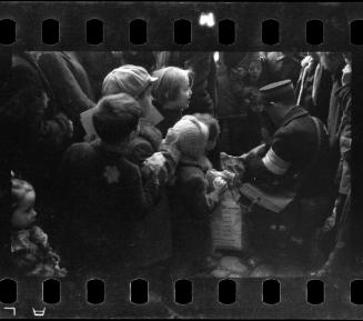 Postal worker distributing goods to children and residents in the ghetto