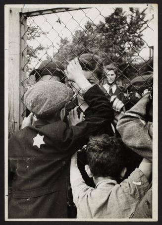 Children talking through fence of central prison on Czarnecki Street prior to deportation