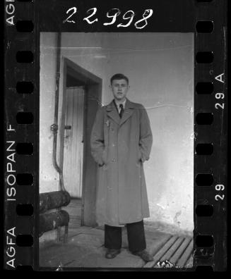 Ghetto resident in a trench coat (with a yellow star of David badge on his chest)