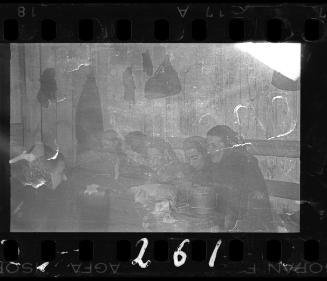 Group of women at a table wearing head scarves