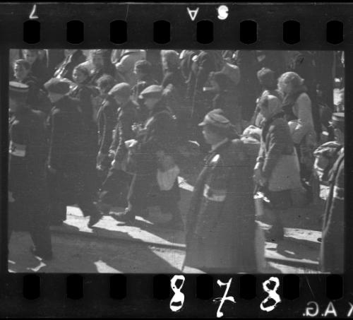 Jewish policemen walking with residents being deported from the ghetto