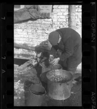 Man holding scraps from a pot