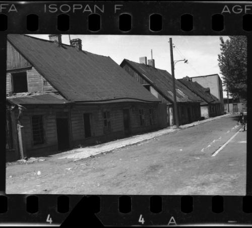 Empty road and wooden houses with chimney