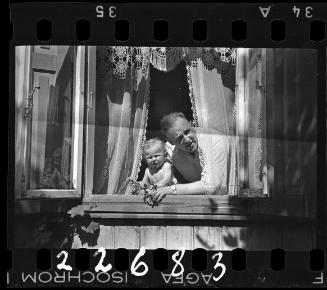 Man and a boy looking out the window