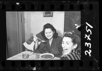 Stefania Schoenberg and her friend, eating soup and smiling