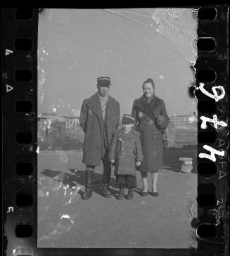 Jewish policeman with family; son wearing policeman's hat