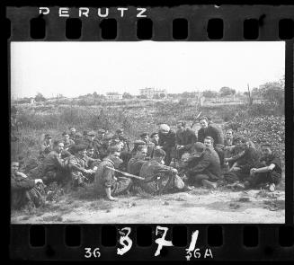 Group of young men sitting in a field in the ghetto