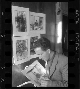 Mendel Grossman with portraits of German officers and administrators