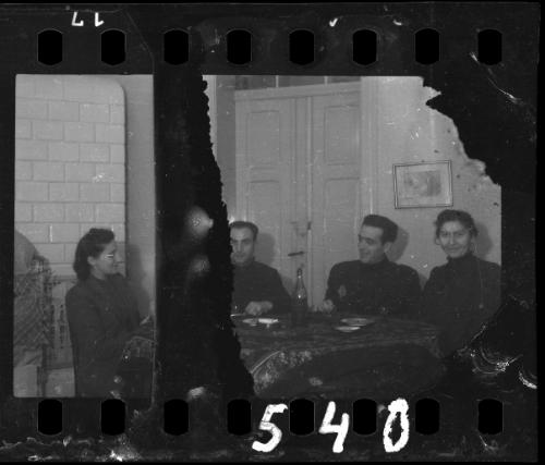 Four ghetto residents sitting around a table
