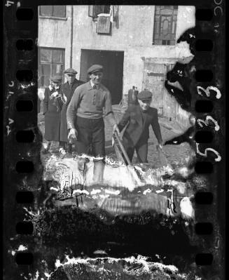 Young man pushing a wheelbarrow
