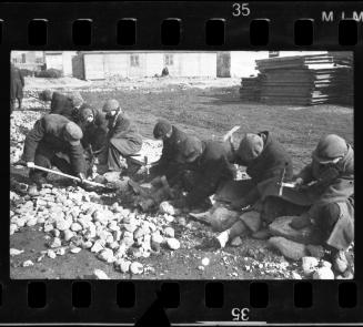 Workers breaking rocks