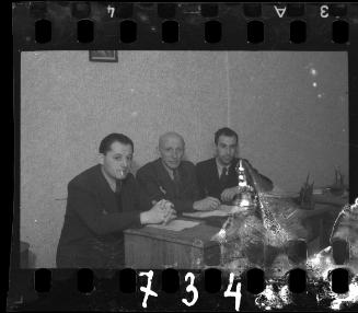 Three Jewish administrators sitting at a desk