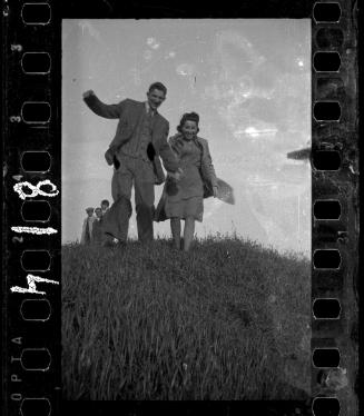 Couple running down a hill