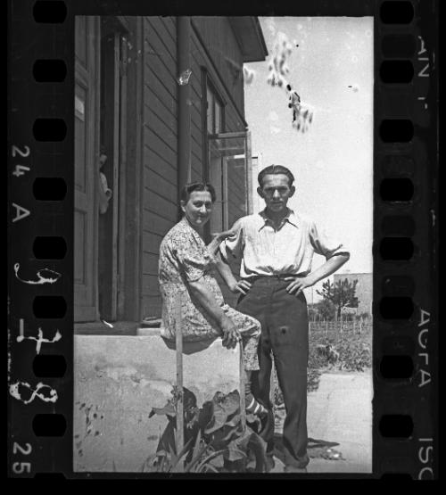 Couple in front of a wooden house