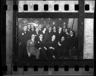 Group portrait of well dressed men and a woman