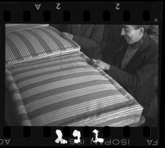 Woman sewing a mattress at the Holzwollefabrik workshop ("ressort") in the ghetto