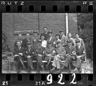 Group portrait of Jewish policeman and four unidentified women in the ghetto