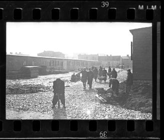 Men working on a road in the ghetto