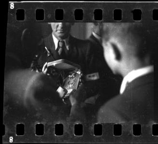 Mordechai Chaim Rumkowksi, Elder of the Jews, holding a Star of David medal