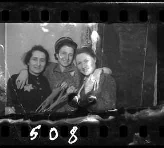 Woman wearing Jewish police officer's hat celebrating with friends