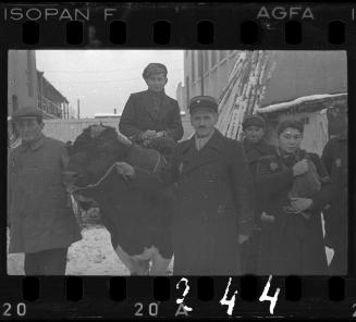 Workers of the Transport Department with a cow in the ghetto