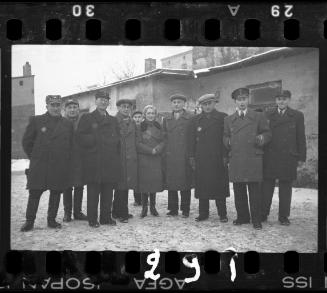 Workers of the Transport Department standing outside of a building in the winter