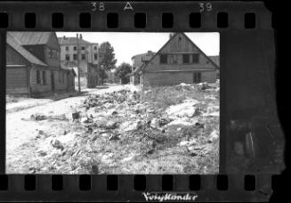 Deserted street covered with discarded pails left behind by residents sent for deportation
