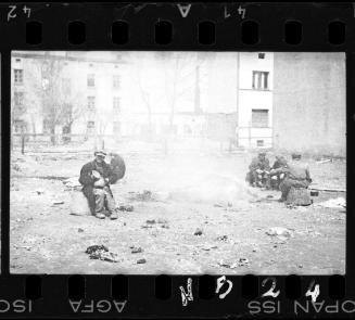 Residents sitting in an empty lot