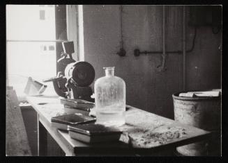 Workbench with trays and glass jar