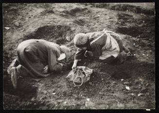 Elderly residents digging for food in the ground