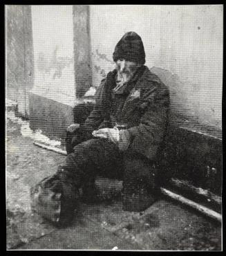 Elderly man on street with feet bundled in rags
