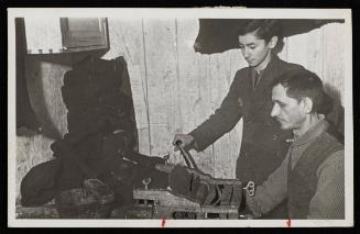 Two workers operating machinery