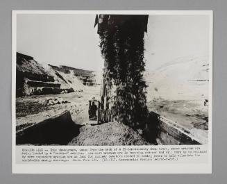 Uranium mine showing uranium ore being loaded by a "backhoe" machine.