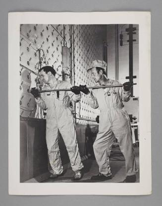 Workers load nuclear rods in reator at Oak Ridge National Laboratories
