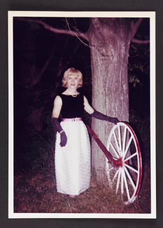 [Jody standing by the wagon wheel at night, Casa Susanna, Hunter, NY]
