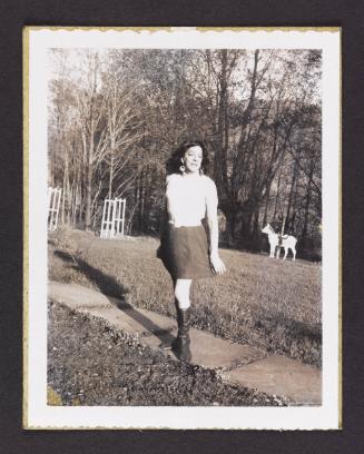 [Susanna posing on the walkway outside, location unknown]
