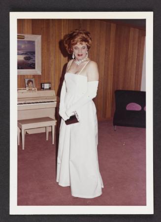 [Gloria in a white gown in front of piano, location unknown]
