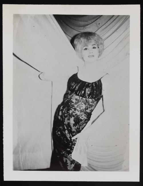 [Blonde posing in front of white curtains, location unknown]
