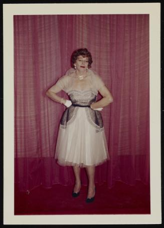 [Anita in a white and black chiffon dress in front of curtains, Chevalier d'Eon, Hunter, NY]
