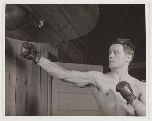 man hitting punching bag